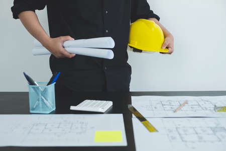 Architects or engineers working construction and drawing construction plans, printing, writing on-site construction sites. Home design concept.の写真素材