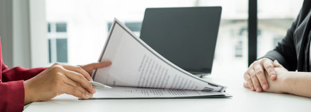 Business people hold a resume and talk to job applicants for job interviews about careers and Their personal history in the company. Recruitment concepts.の写真素材