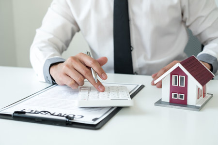 Agents working in real estate investment Hold the key home Ready home insurance signing contracts in accordance with the home buying insurance agreements approving purchases for clients.の写真素材