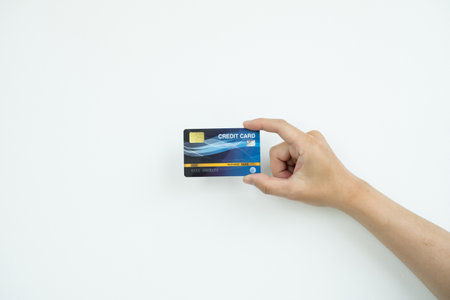 The hand holding a credit card is used for online shopping and Internet payments.