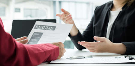 Business people hold a resume and talk to work applicants for work interviews about careers and...