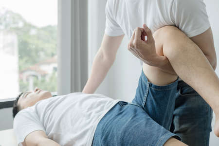 Male patients consulted physiotherapists with knee pain problems for examination and treatment. Rehabilitation physiotherapy concept.の写真素材