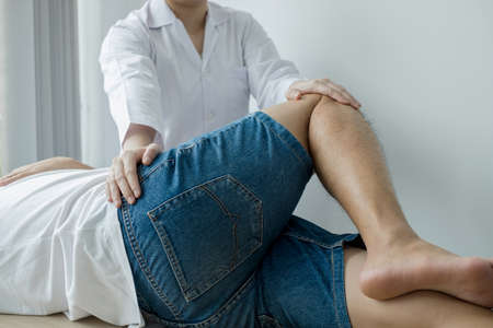 Male patients consulted physiotherapists with knee pain problems for examination and treatment. Rehabilitation physiotherapy concept.の写真素材