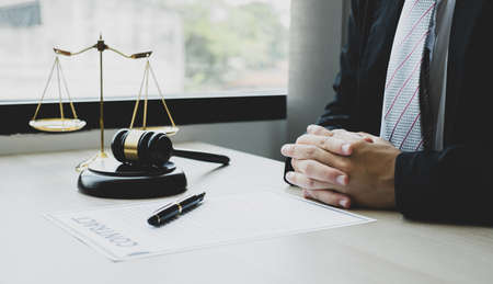 Professional man lawyers work at a law office There are scales, Scales of justice, judges gavel, and litigation documents. Concepts of law and justice.の写真素材