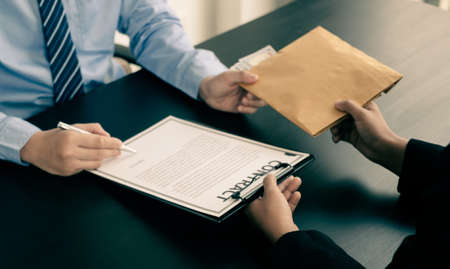 Corruption. Businessmen make an agreement with the money proposed his partner to bribe in the office and make a contract under an agreement. Illegal money fraud The concept of bribery and corruption.の写真素材