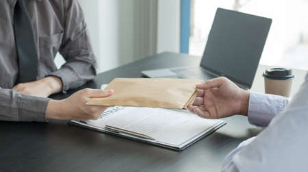 Corruption. Businessmen make an agreement with the money proposed his partner to bribe in the office and make a contract under an agreement. Illegal money fraud The concept of bribery and corruption.の写真素材