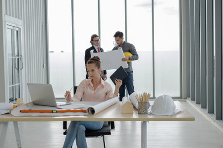 Team of male and female engineers and architects, working team, meeting, discussing construction and...