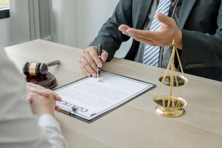 A man lawyer or a judge counseling clients about judicial justice and prosecution with scales,...