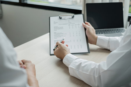 Man doctors explain and recommend treatment after a female patient meets a doctor and receives results regarding illness problems. Medical and health care concepts.の写真素材