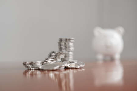 piggy bank with golden coins pile, step up growing business to success, and saving for retirement...