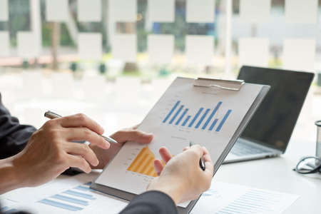 Business leaders talk about charts, financial graphs showing results are analyzing and calculating...