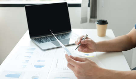 work from home, The hand of a man who works in finance sits at his desk at home and calculates...