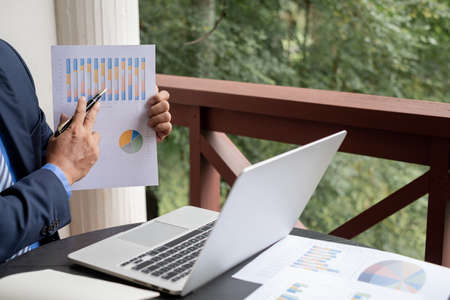work from home, The hand of the businessman who works in finance at home and calculates financial...