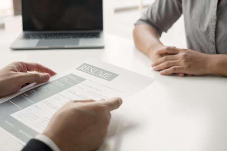 Business people hold a resume and talk to job applicants for job interviews about careers and Their...