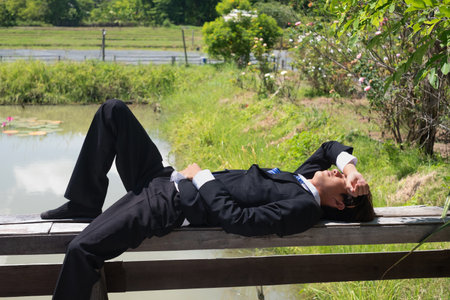 Young Asian businessman suffers from depression and stress is laid off due to economic problems feels hopeless has financial anxiety.の写真素材