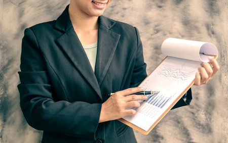Businesswomen or accountants working on financial investment, calculating, analyzing, and marketing on graphs showing the results of their investments to plan a successful business growth process.の写真素材