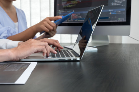 Team of programmers working with computer programming, professional development, and coding technology, working on high-quality visual software development websites.の写真素材