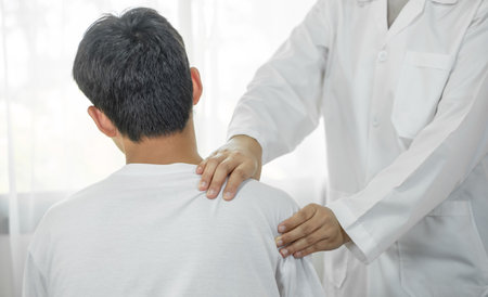 patients with shoulder injuries massaging their shoulders for muscle recovery in the rehabilitation center. Physiotherapy concepts.の写真素材