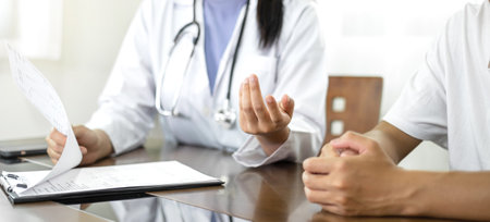 Female doctors who treat patients make an appointment to listen to the results after a physical examination and explain medical information and diagnose the disease. Medical concepts and good health.の写真素材