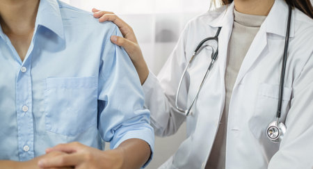 The female doctor uses a friendly hand to hold the touch shoulder to give confidence and show care about health care. Medical concepts and good health.の写真素材
