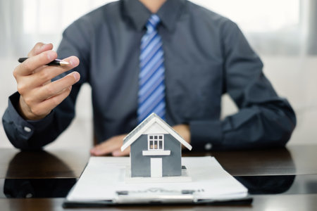 Agents working in real estate investment and home insurance signing contracts in accordance with the home buying insurance agreements approving purchases for clients.の写真素材