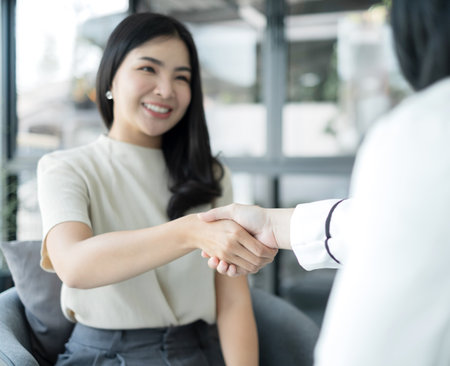 businesswoman shake hands after the meeting was successful and agreed upon.の写真素材