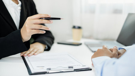 HR Managers hold a resume and talk to job applicants for job interviews about careers and Their...