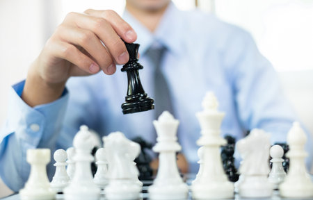 hand of businessmen moving chess in competition shows leadership, followers, and business success strategies.の写真素材