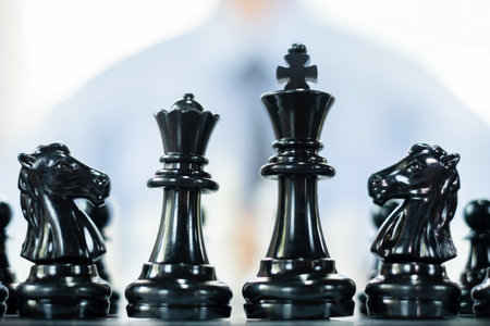 hand of businessmen moving chess in competition shows leadership, followers and business success strategies.の写真素材