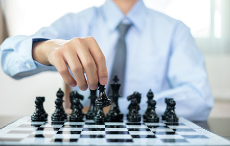 hand of businessmen moving chess in competition shows leadership, followers and business success strategies.の写真素材