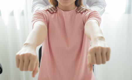 Female physiotherapists provide physical assistance to patients with shoulder injuries massaging their shoulders for muscle recovery in the rehabilitation center. Physiotherapy concepts.の写真素材