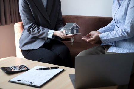 Real estate agents offer sale home insurance is talking to clients about buying home insurance. Home insurance concept.の写真素材
