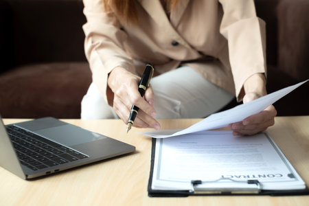 Business woman employer holding resume hiring recruit looking cv resume to hire candidates, analyzing information before job interview. Recruitment concepts.の写真素材