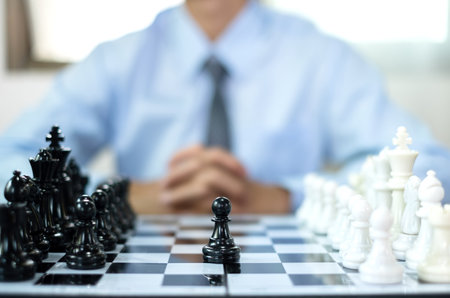 hand of businessmen moving chess in competition shows leadership, followers and business success strategies.の写真素材