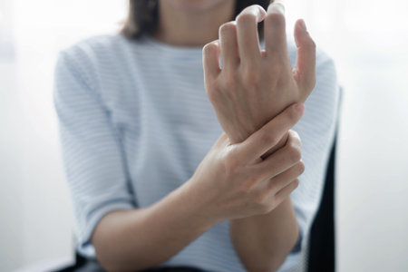 Woman hand with wrist pain numbness and pain in the palm of the hand has pain and tingling in the nerve endings This is a side effect of sitting and working for a long time on a laptop at the office.の写真素材