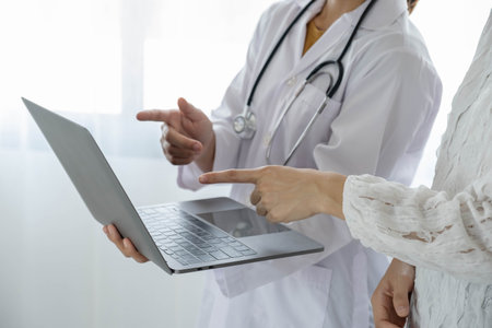 Female doctors who treat patients make an appointment to listen to the results after a physical examination and explain medical information and diagnose the disease. Medical concepts and good health.の写真素材