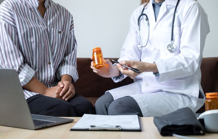 Female doctors who treat patients make an appointment to listen to the results after a physical examination and explain medical information and diagnose the disease. Medical concepts and good health.の写真素材
