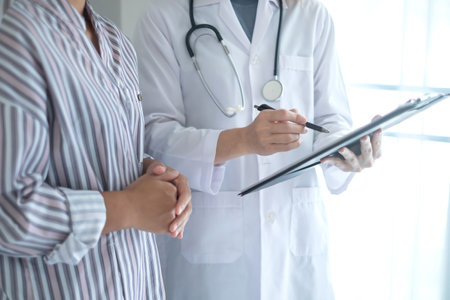 Female doctors who treat patients make an appointment to listen to the results after a physical examination and explain medical information and diagnose the disease. Medical concepts and good health.の写真素材