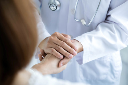 The female doctor uses a friendly hand to hold the patient's hand to give confidence and show care about health care. Medical concepts and good health.の写真素材