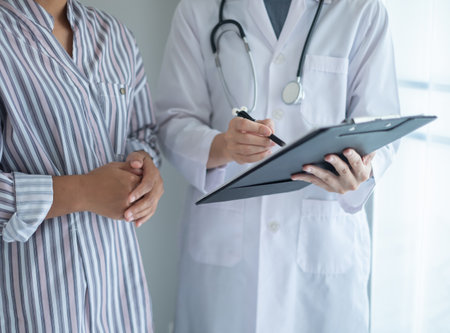 Female doctors who treat patients make an appointment to listen to the results after a physical examination and explain medical information and diagnose the disease. Medical concepts and good health.の写真素材