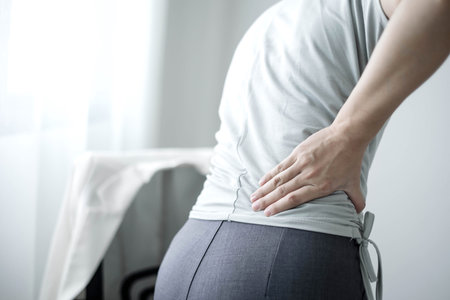 Woman having back body pain during work long time. stretching to relax and relax while working hard...