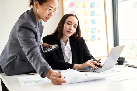 Business leaders talk about charts, financial graphs showing results are analyzing and calculating planning strategies, business success building processes.の写真素材