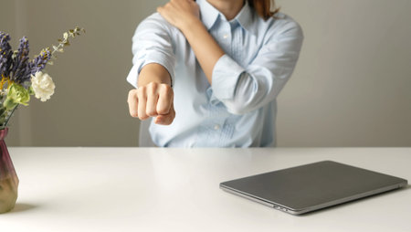 Asian female accountant is tired from working in a chair, stretching to relax and relax while...