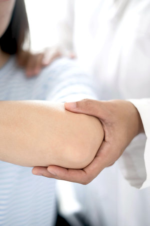 Female physiotherapists provide physical assistance to women patients with elbow injuries examine patients in rehabilitation centers. Physiotherapy concepts.の写真素材