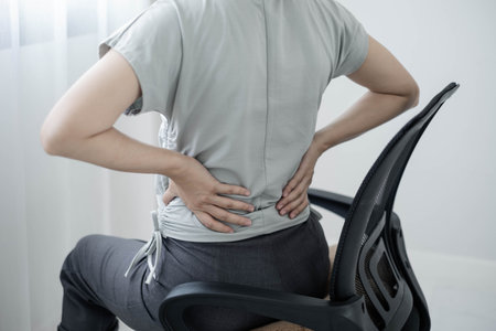 Woman having back body pain during work long time. stretching to relax and relax while working hard...