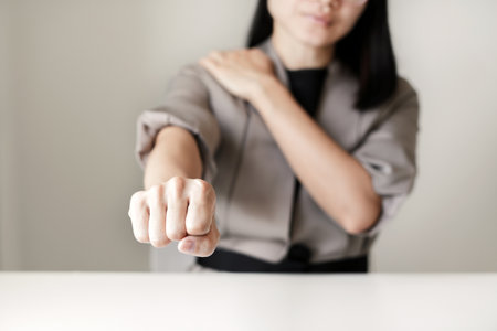 Woman having shoulder pain pain during work long time. stretching to relax and relax while working hard at the office.の写真素材