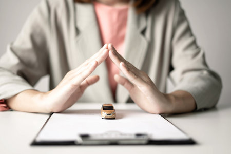 Car dealer businesswoman signing car insurance document or lease paper. Car insurance, loans and Car rentals concept.の写真素材