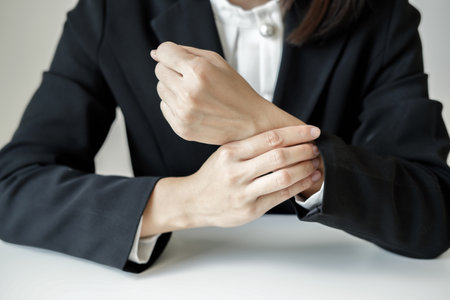 Woman hand with wrist pain numbness and pain in the palm of the hand has pain and tingling in the nerve endings This is a side effect of sitting and working for a long time on a laptop at the office.の写真素材