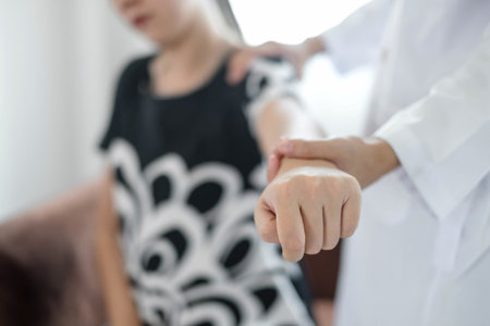 Female physiotherapists provide physical assistance to patients with shoulder injuries massaging their shoulders for muscle recovery in the rehabilitation center. Physiotherapy concepts.の写真素材