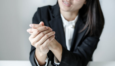Woman hand with wrist pain numbness and pain in the palm of the hand has pain and tingling in the nerve endings This is a side effect of sitting and working for a long time on a laptop at the office.の写真素材